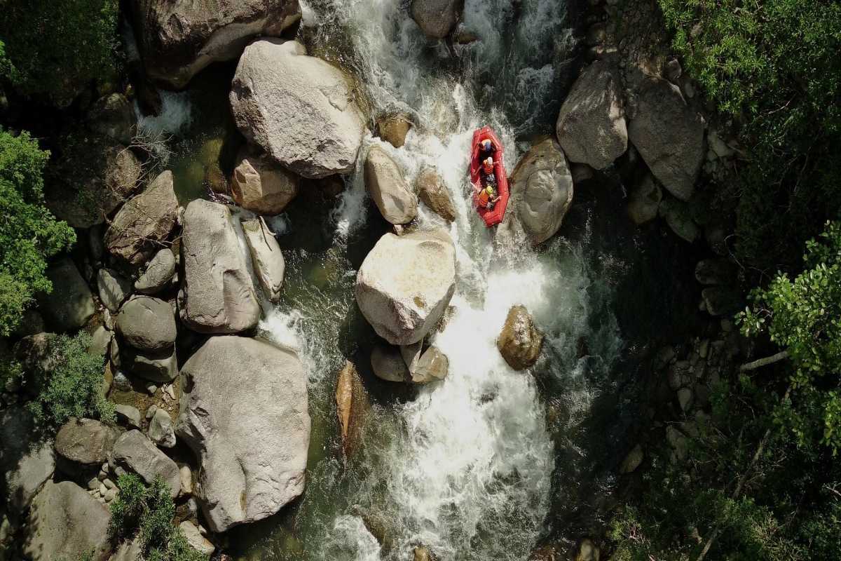 Kong Forest River Rafting Adventure Group rafting down rocky river rapids inside Kong Forest at Hon Ba Nature Reserve