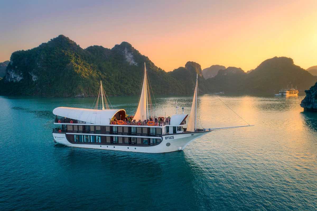 Lan Ha Bay Vietnam floating fishing village near limestone cliffs Floating fishing village in Lan Ha Bay nestled near dramatic limestone cliffs and tranquil green waters.