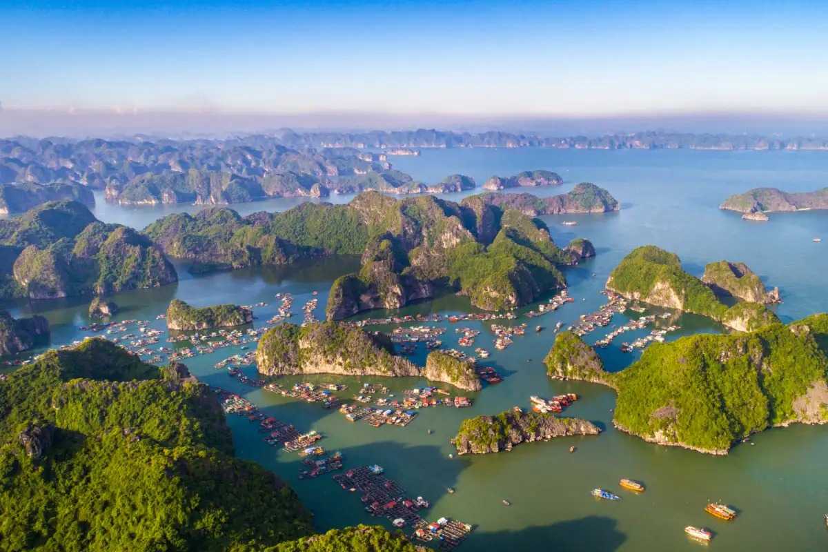 Lan Ha Bay Vietnam floating fishing village panorama Lan Ha Bay Vietnam viewed from above with floating fishing villages, limestone islands, and emerald waters