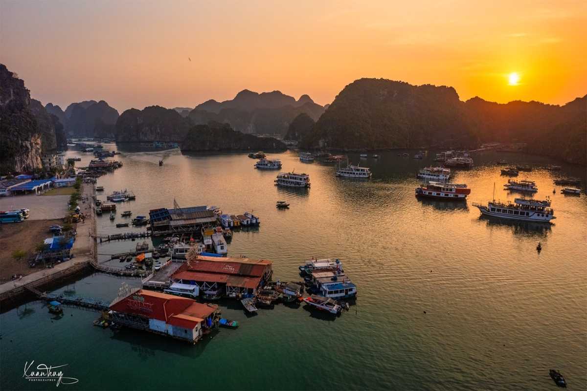 Lan Ha Bay Vietnam kayakers exploring calm waters Tourists kayaking through the calm, jade-green waters of Lan Ha Bay beneath limestone formations.