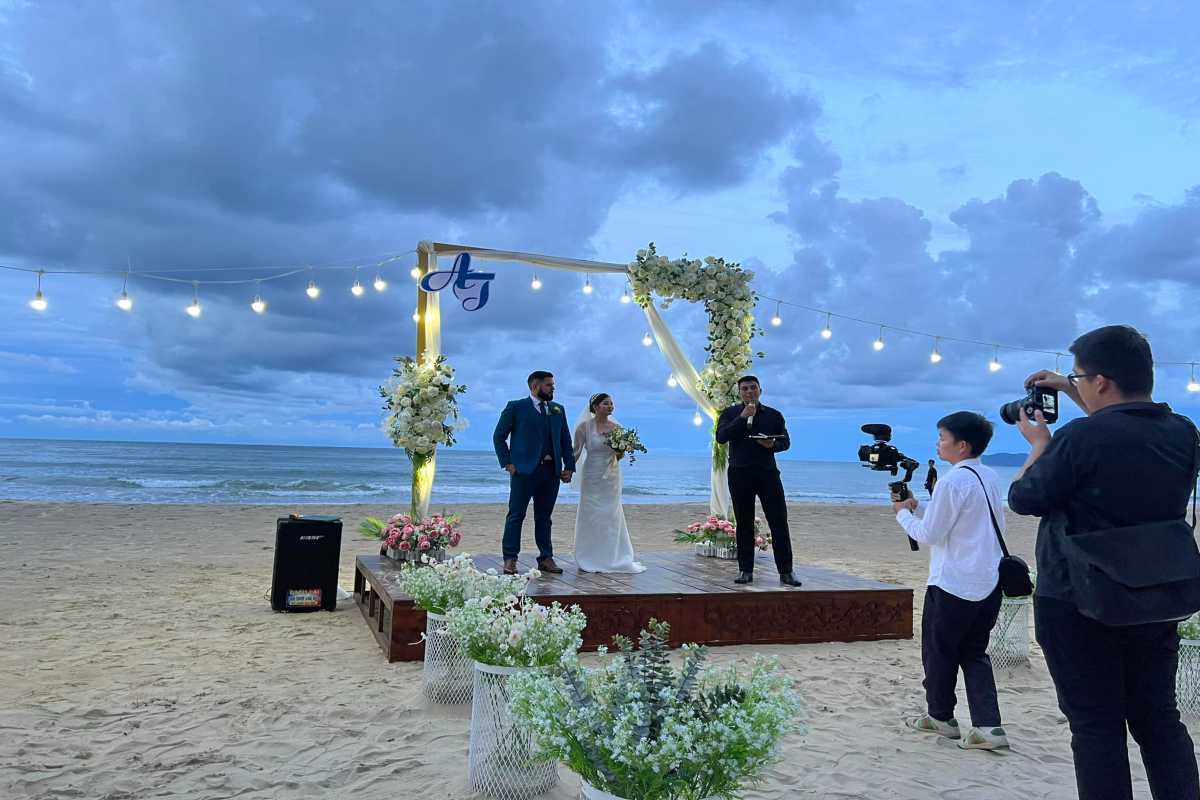 Lang Co Beach Hue beach wedding celebration at dusk Lang Co Beach Hue hosts a romantic wedding ceremony on the sand at sunset, with floral decorations and festive atmosphere.