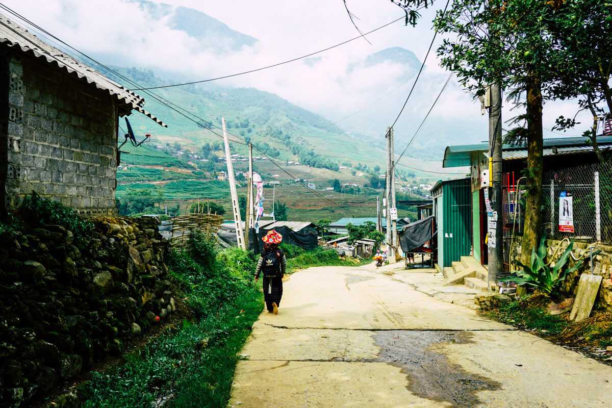 Lao Chai Village Sapa rural road and village entrance Lao Chai Village Sapa village road leads through traditional houses with terraced fields and misty mountains