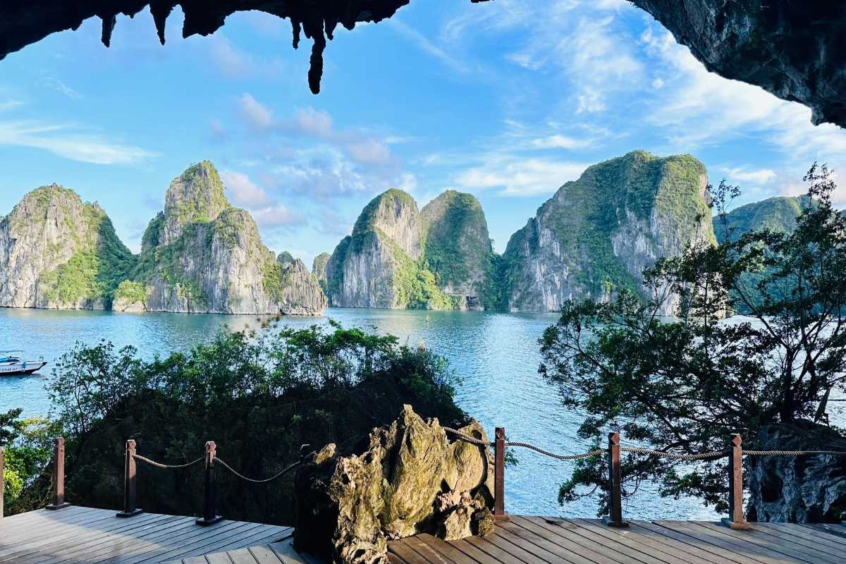 Limestone cliffs and karst formations framing Drum Cave entrance Majestic limestone cliffs and karst formations surrounding the entrance of Drum Cave Halong Bay, a natural marvel.