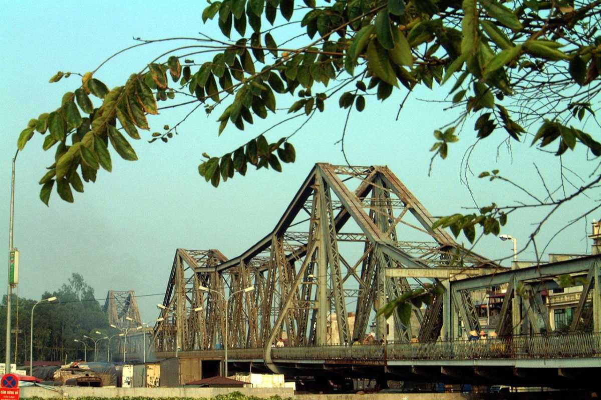 Long Bien Bridge Hanoi Blue Sky View Blue sky backdrop with Long Bien Bridge crossing lush green fields