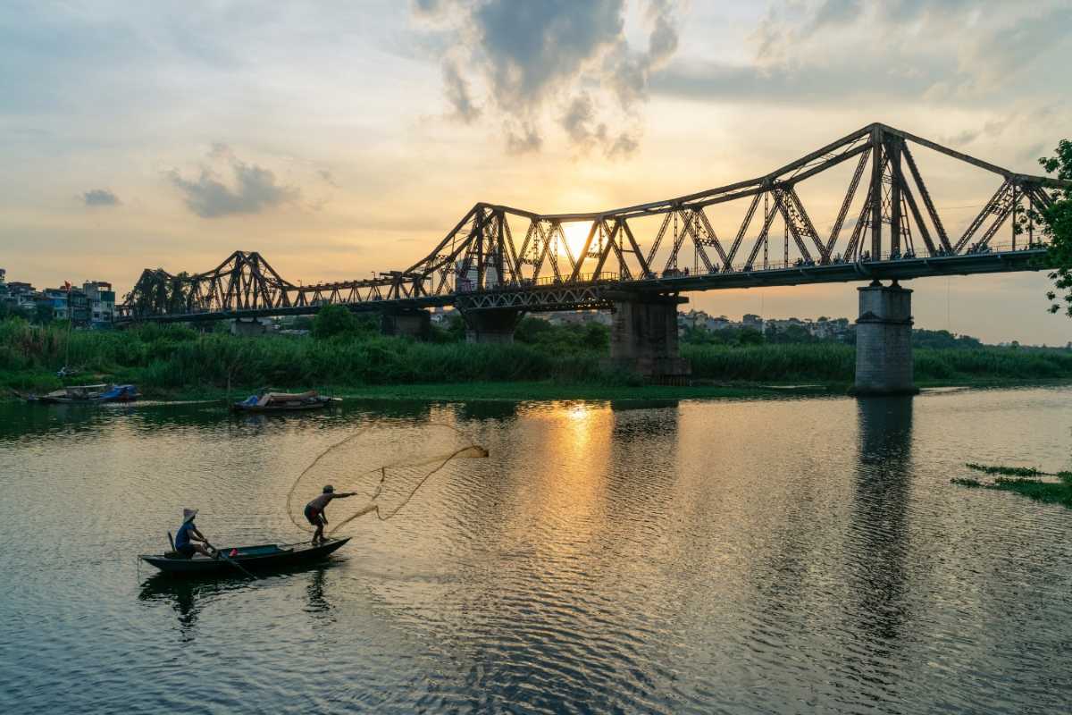 Long Bien Bridge Hanoi Sunset Silhouette Silhouette of Long Bien Bridge at sunset with warm orange sky