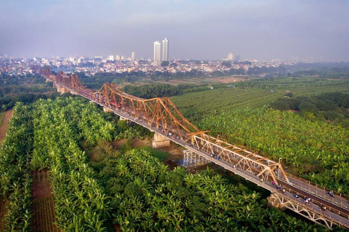 Long Bien Bridge Over Lush Green Fields Long Bien Bridge spanning wide lush green fields on the outskirts of Hanoi
