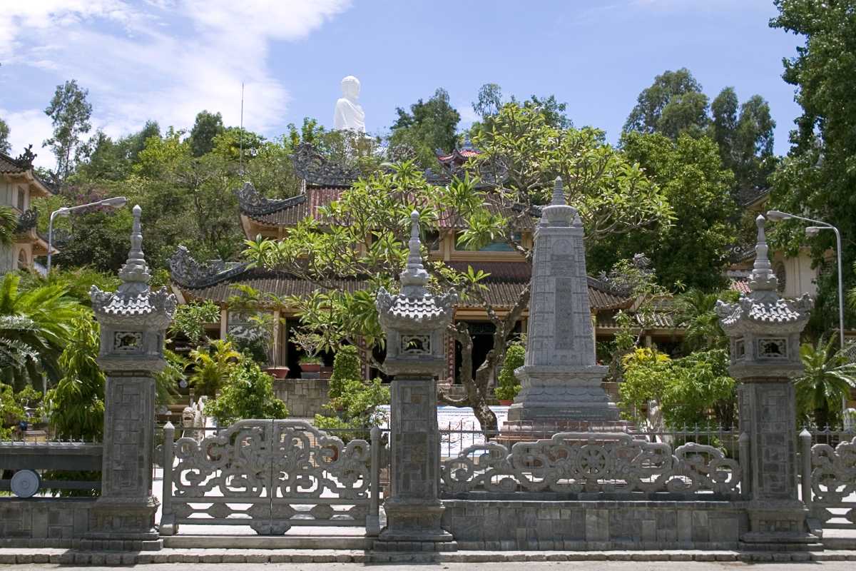 Front Gate of Long Son Pagoda Main gate and intricate stonework at Long Son Pagoda in Nha Trang with trees and temple roof visible.
