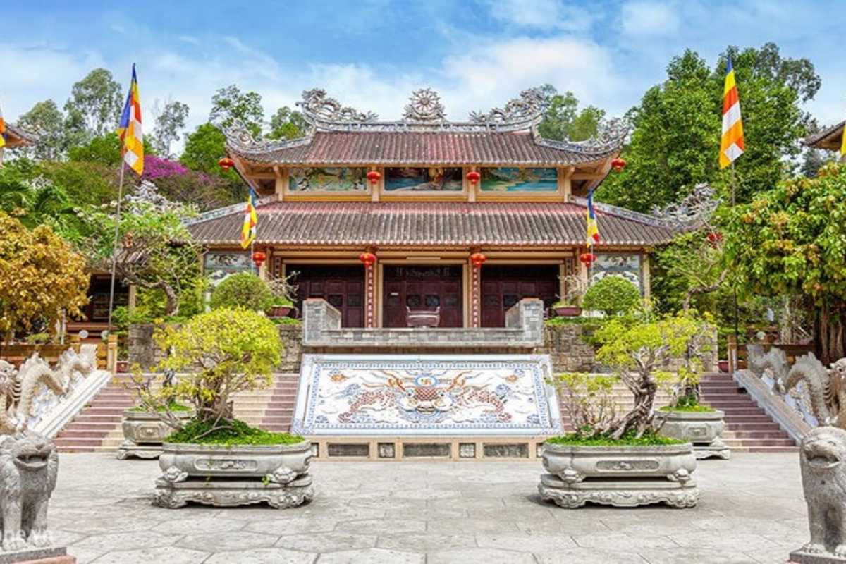 Front Facade of Main Temple Hall Main hall of Long Son Pagoda with dragon decorations and symmetrical steps leading to entrance.