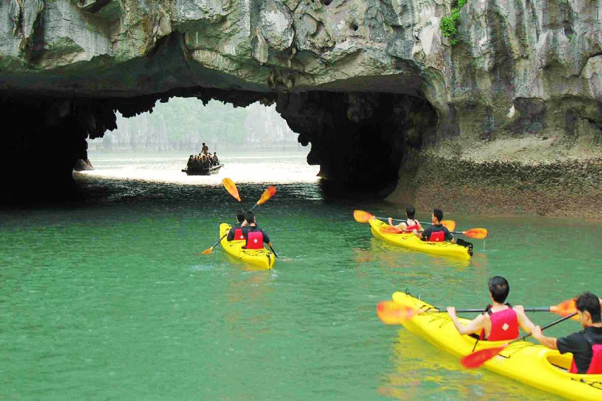 Luon Cave Halong Bay Bamboo Boat Tour Approaching Cave Bamboo boat tour approaching limestone cave entrance at Luon Cave, Halong Bay