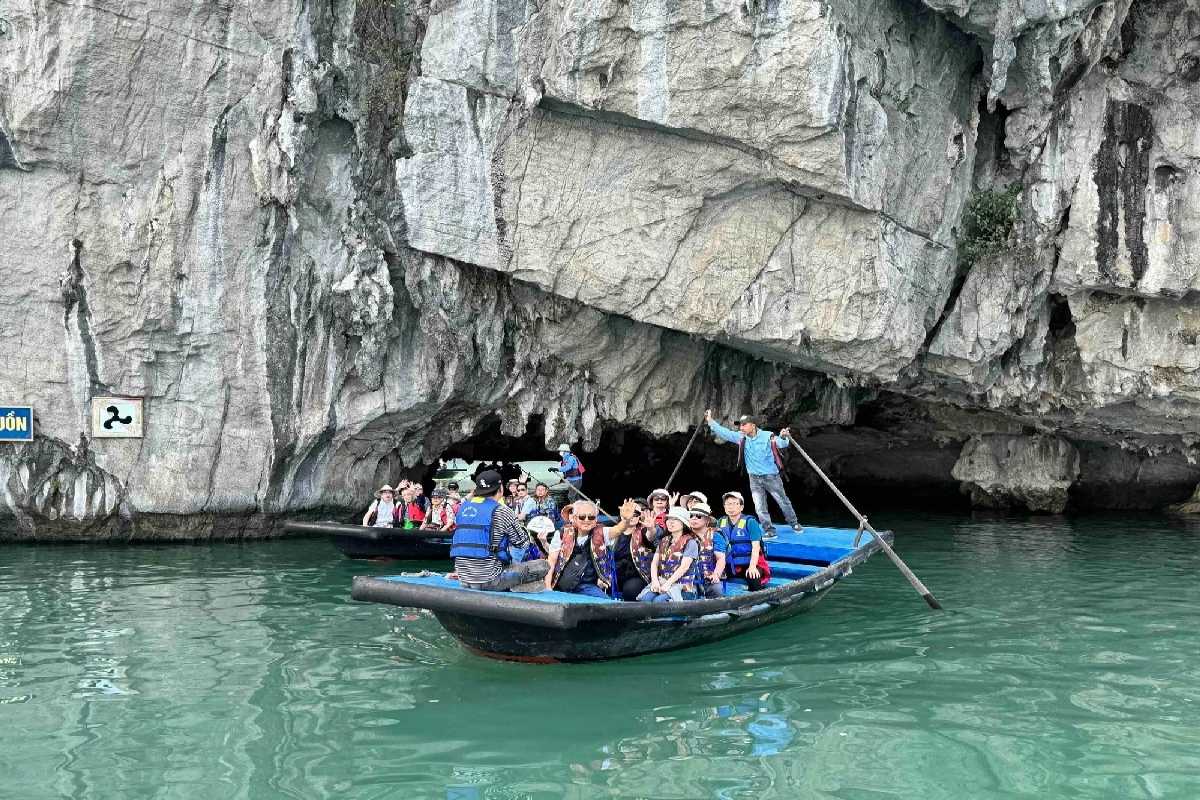 Luon Cave Halong Bay Visitors Kayaking Towards Cave Entrance Kayakers paddling towards the limestone cave entrance of Luon Cave, Halong Bay