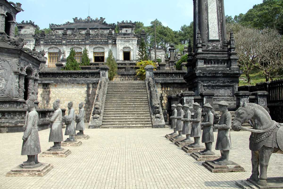 Mandarin statues facing imperial staircase Rows of mandarin and soldier statues lining the entrance to Khai Dinh Tomb in Hue