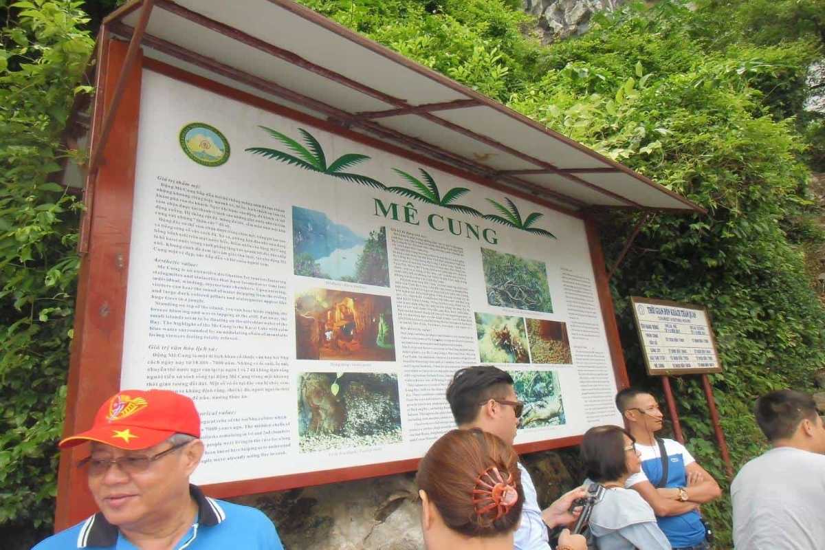 Me Cung Cave Halong Bay entrance signboard and visitor group Entrance signboard at Me Cung Cave Halong Bay with visitors gathering before the cave tour