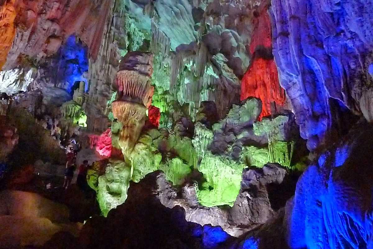 Me Cung Cave Halong Bay vibrant illuminated interiors Vibrant illuminated interiors of Me Cung Cave Halong Bay showcasing colorful stalactites and stalagmites.