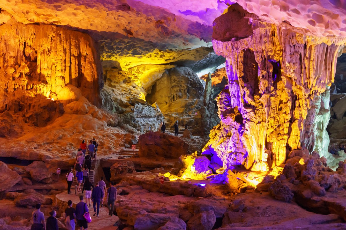 Me Cung Cave in Halong Bay with intricate limestone formations and vibrant lighting.