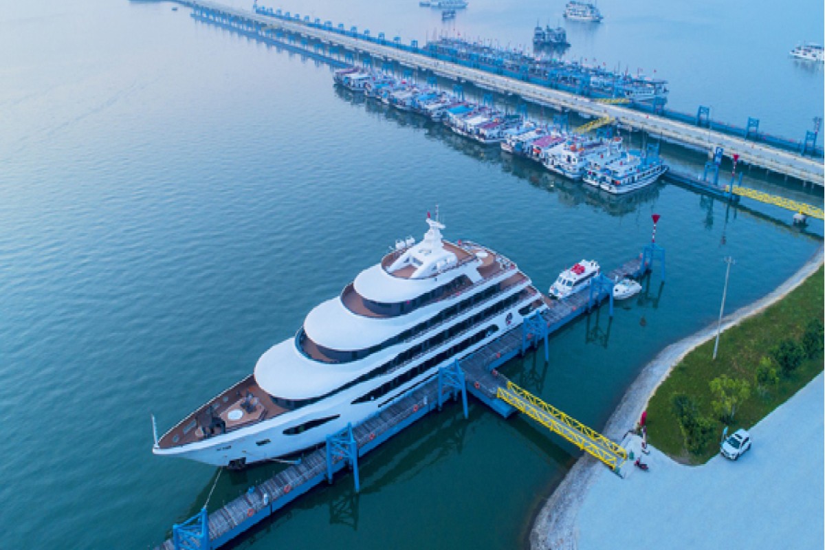 A modern cruise ship docked at Halong International Cruise Port, showcasing its state-of-the-art facilities.