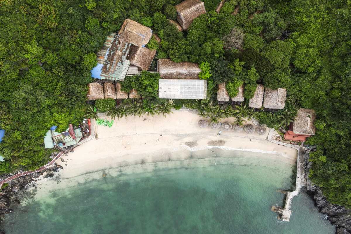 Aerial View of Monkey Island Cat Ba Sandy Beach and Resort Aerial photo showing Monkey Island Cat Ba’s sandy beach with resort buildings nestled in tropical greenery