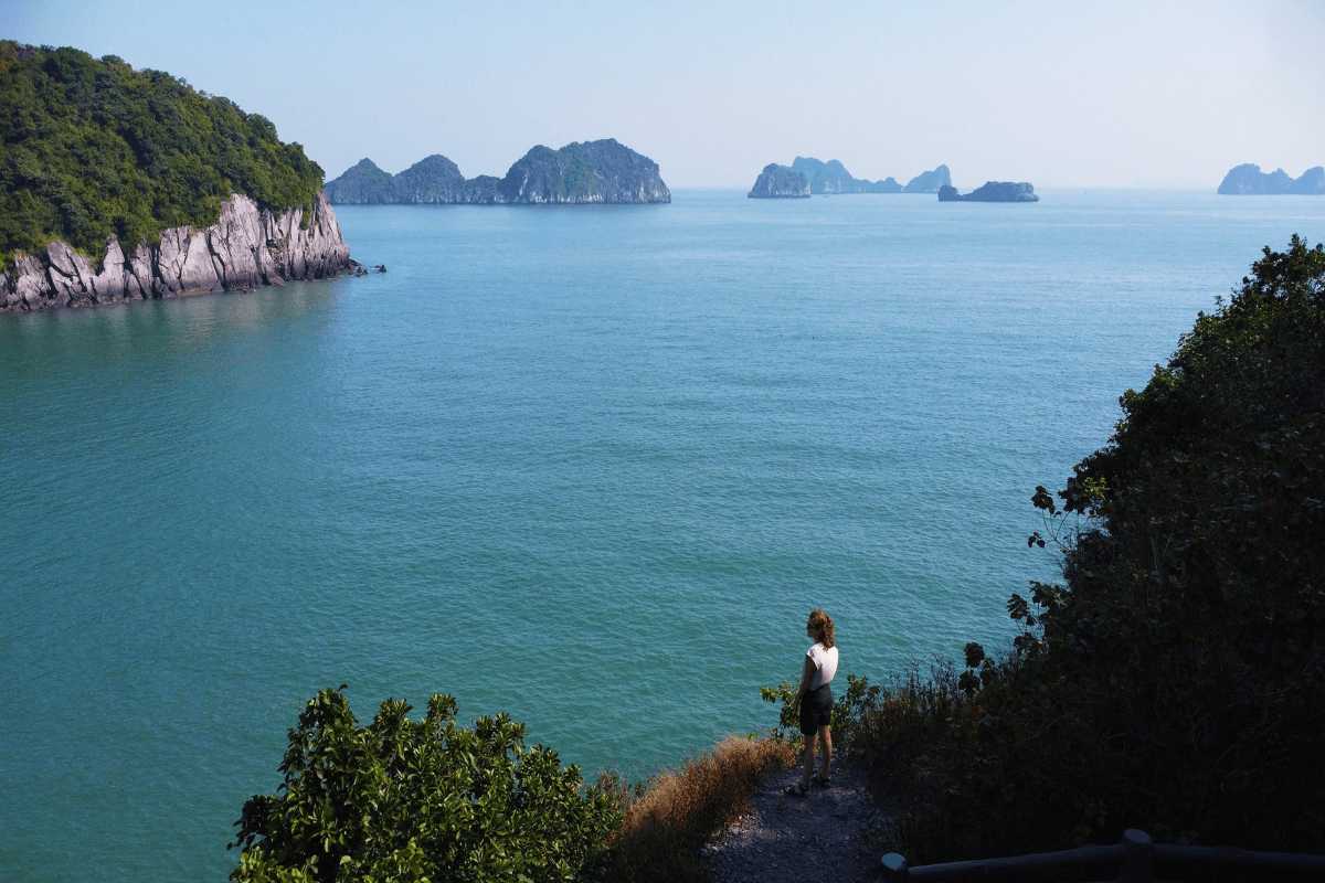 Overlook of Lan Ha Bay and Islands from Monkey Island Cat Ba Visitor gazing over Lan Ha Bay’s turquoise waters and limestone islands from Monkey Island Cat Ba