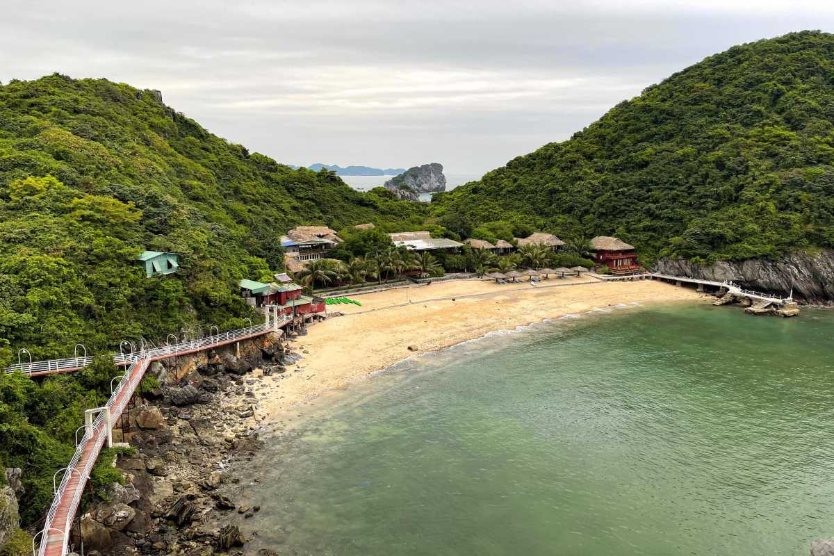 Monkey Island Cat Ba Scenic Beach and Green Hills View Scenic beach with soft sand bordered by lush green hills on Monkey Island Cat Ba in Vietnam
