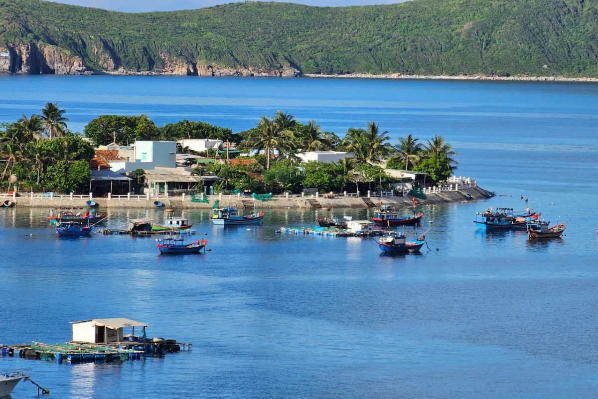 Panoramic View of Mot Island Fishing Village Coastal homes and anchored fishing boats surround the fish cages in the turquoise waters of Mot Island.