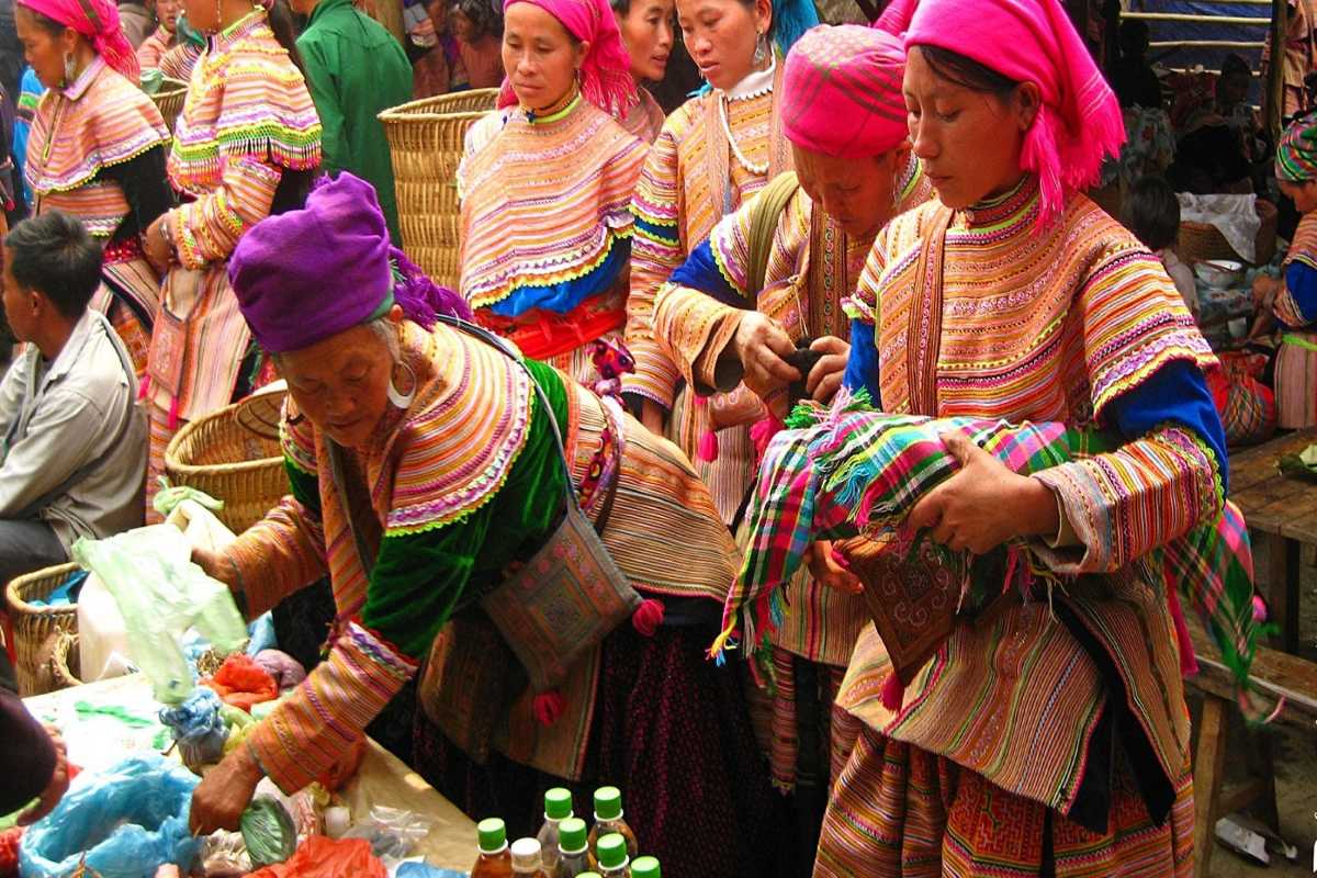 Muong Hum Market Sapa bustling trade and colorful fabrics Muong Hum Market Sapa’s energetic trade features shoppers and vendors surrounded by vibrant, colorful fabrics.