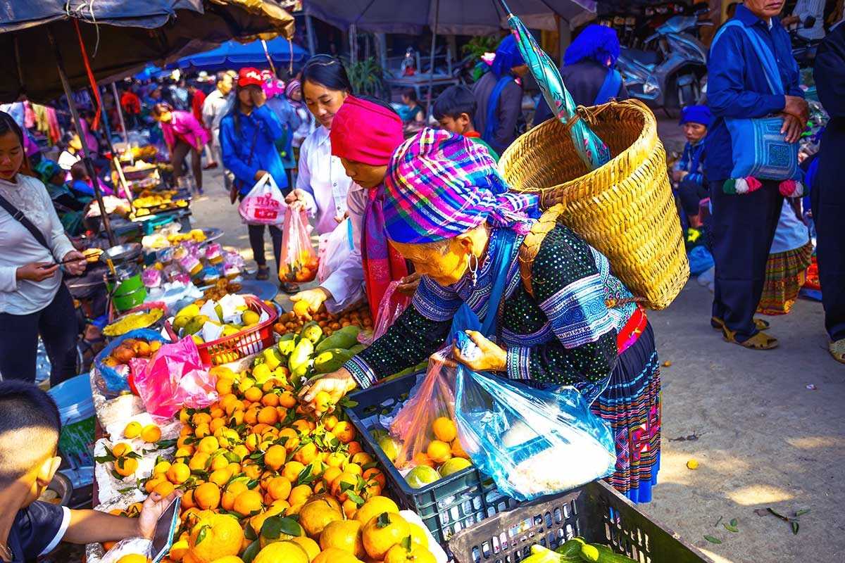 Muong Hum Market Sapa bustling produce stalls and trading Muong Hum Market Sapa showcases bustling fruit stalls with local produce, energetic vendors, and colorful market life.