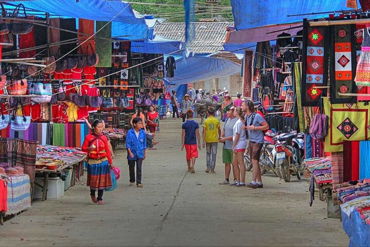 Muong Hum Market Sapa colorful handicraft stalls vibrant morning Muong Hum Market Sapa displays colorful ethnic handicraft stalls, vibrant textiles, and shoppers in the morning.