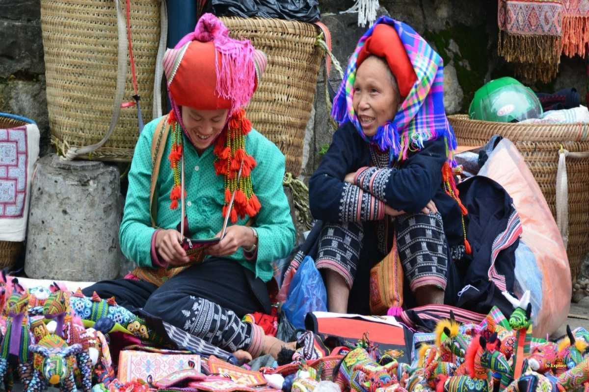Muong Hum Market Sapa ethnic Red Dao vendors and crafts Muong Hum Market Sapa features Red Dao women selling colorful handmade crafts, traditional textiles, and local goods.