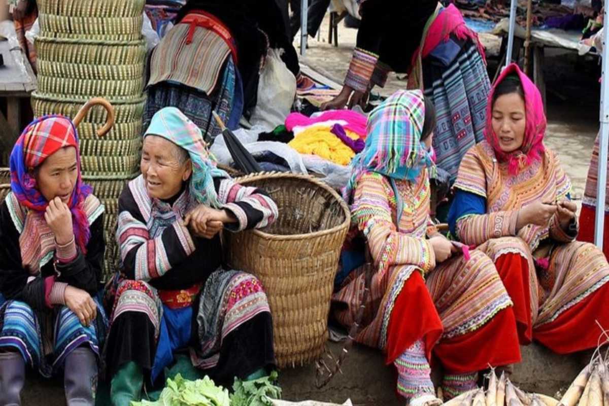 Muong Hum Market Sapa ethnic women local produce trade Muong Hum Market Sapa features ethnic minority women trading local produce and handicrafts, vibrant baskets.