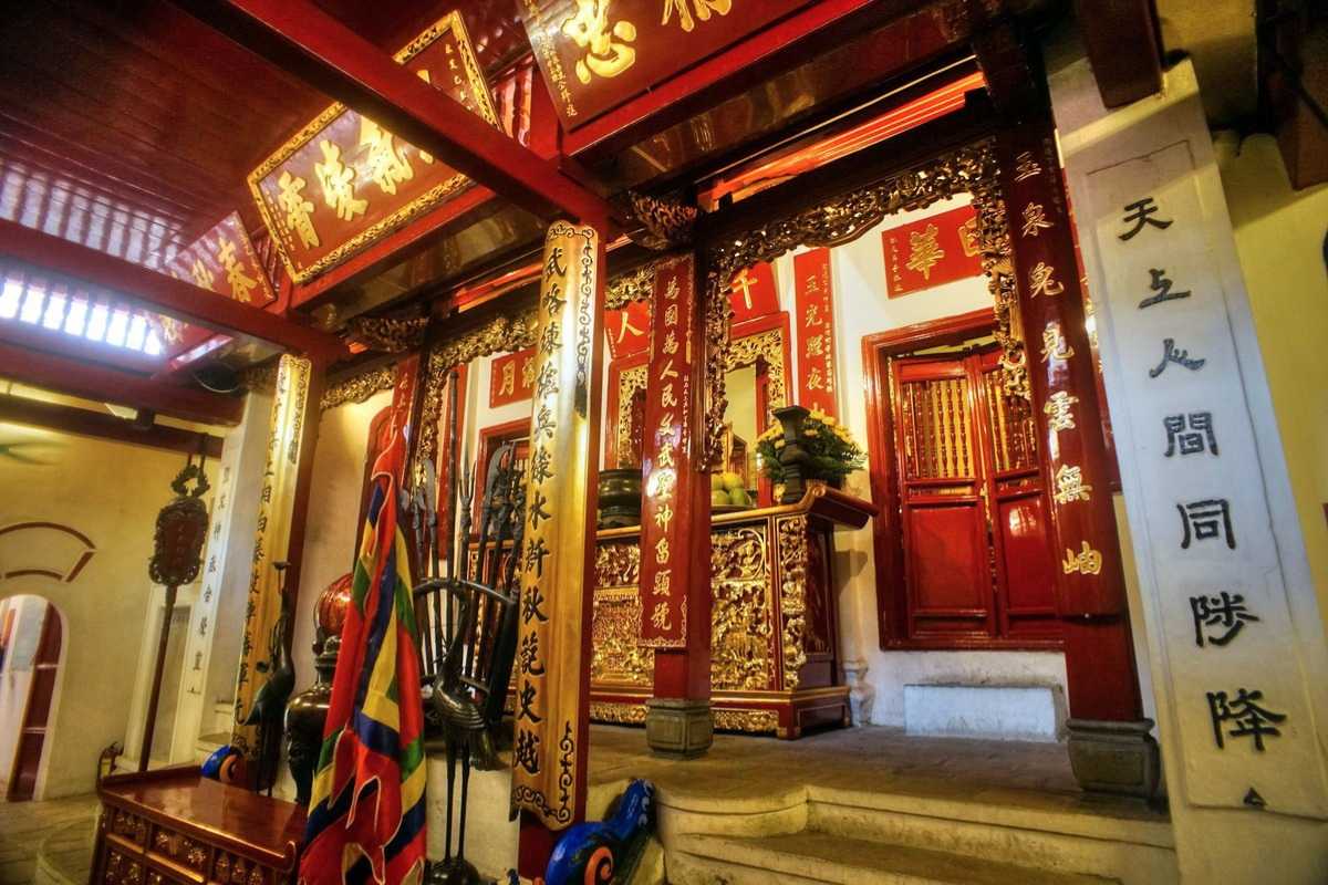 Ngoc Son Temple altar with colorful flags Vibrant altar with colorful traditional flags inside Ngoc Son Temple