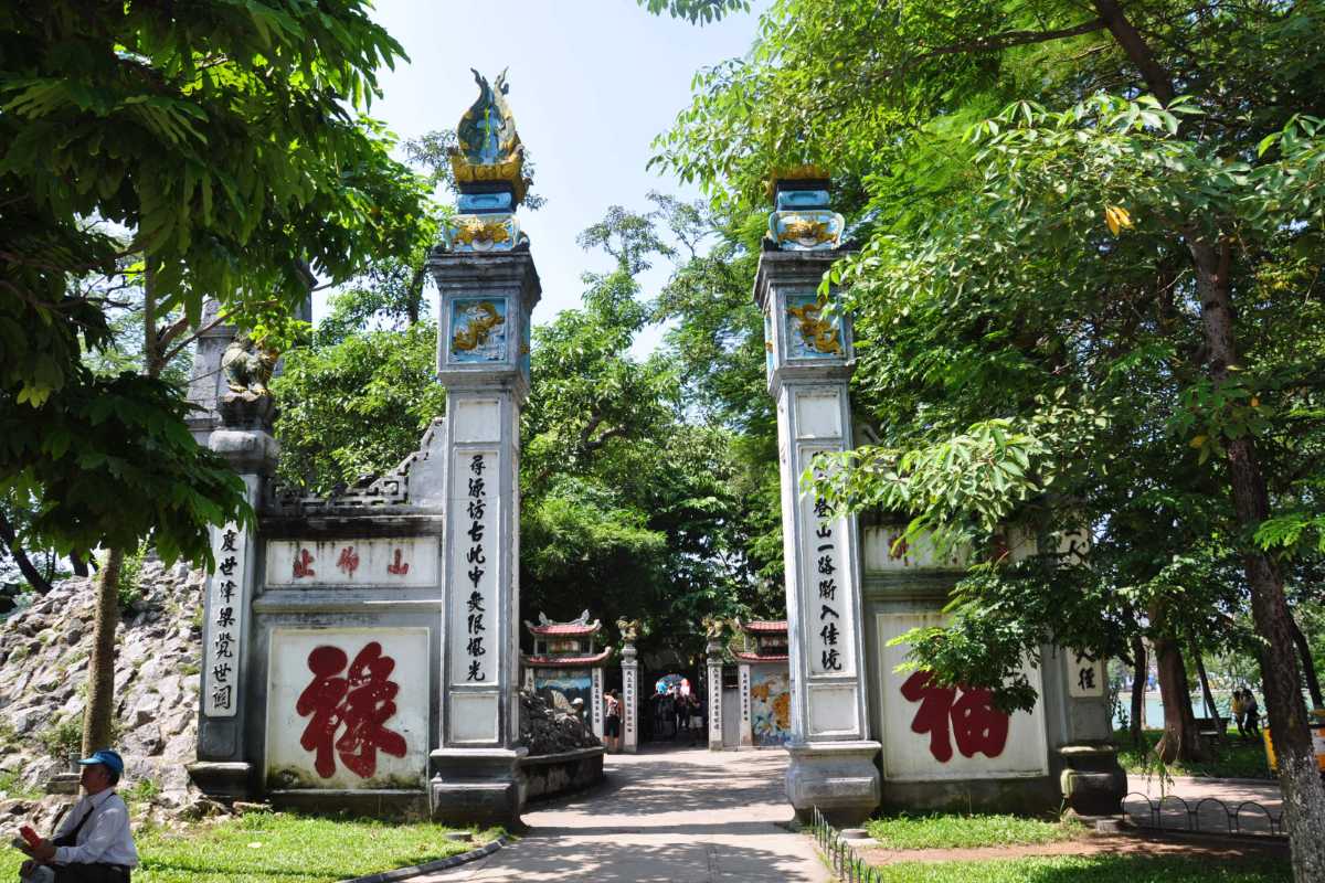 Ngoc Son Temple entrance gate with visitors Entrance gate to Ngoc Son Temple with tourists and locals entering