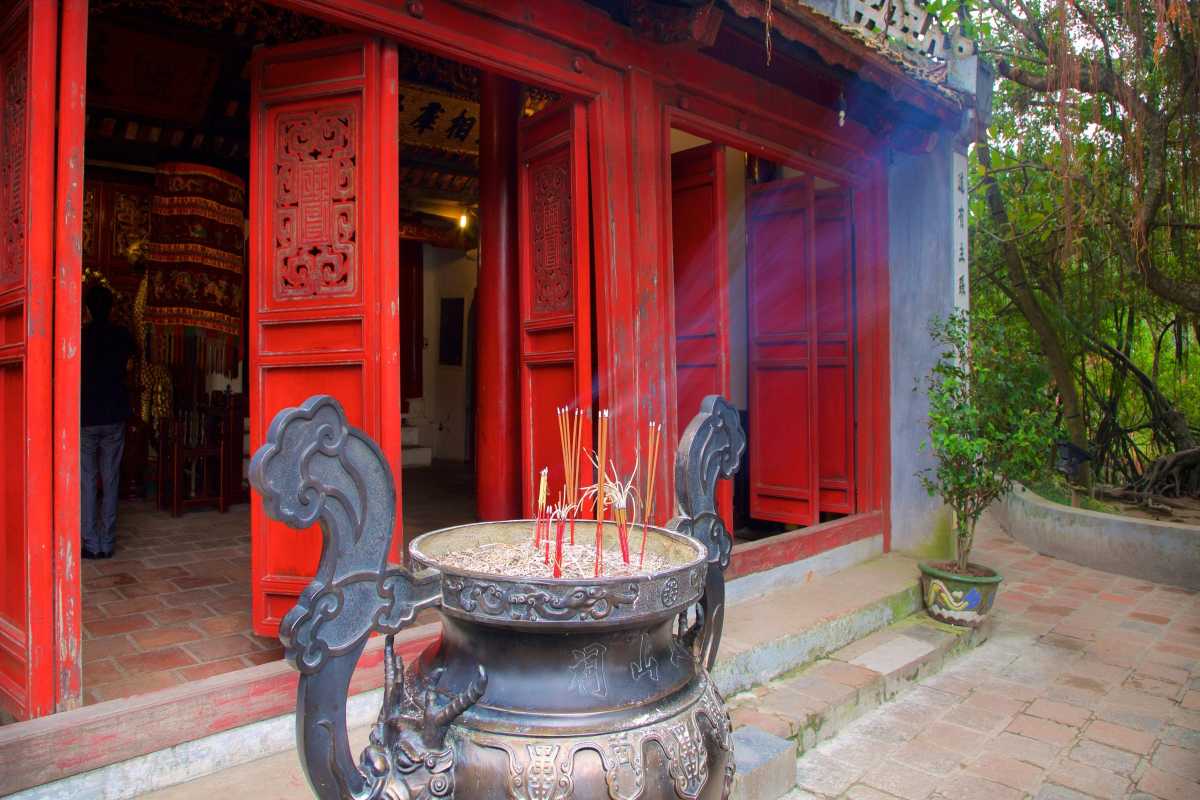 Incense Burner at Ngoc Son Temple Entrance Incense burner with burning incense sticks at the entrance of Ngoc Son Temple in Hanoi
