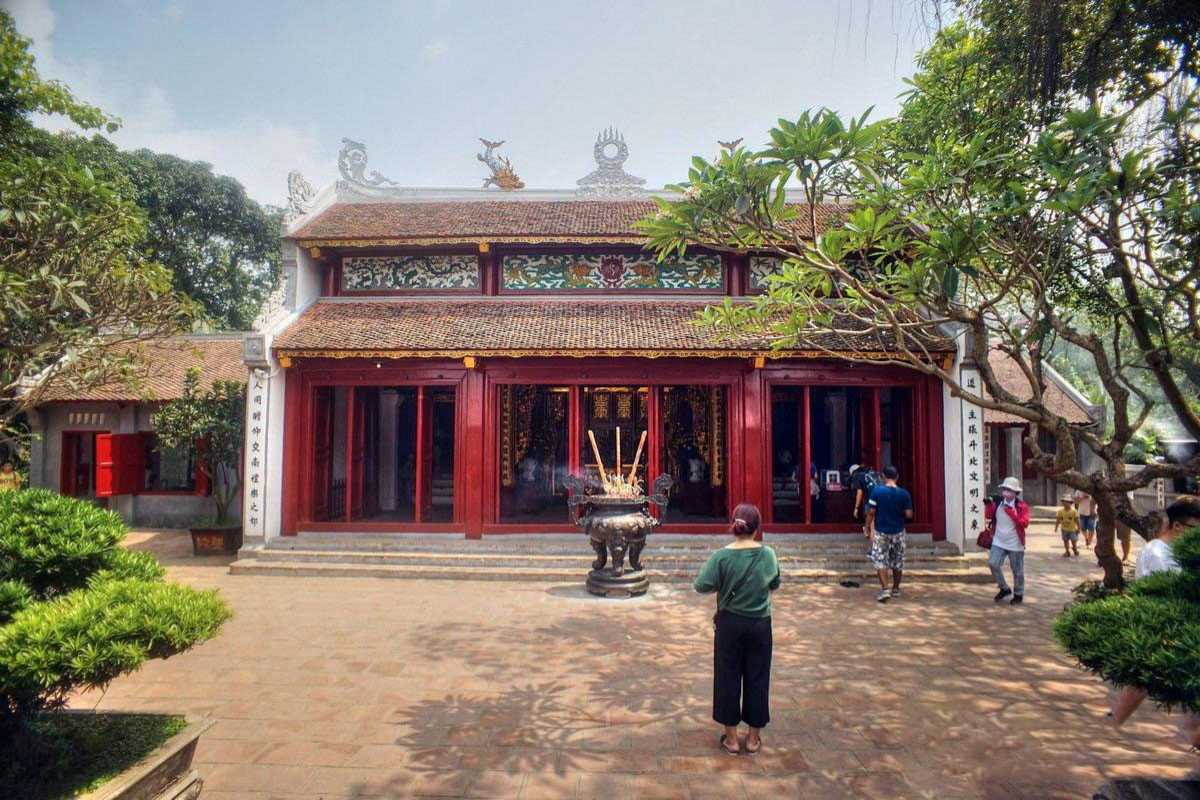 Ngoc Son Temple visitors at entrance gate Tourists and visitors entering Ngoc Son Temple through the ornate stone gate