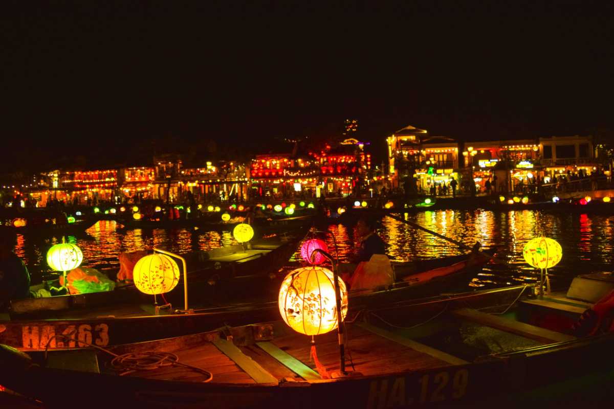 Night View of Lantern Boats on Hoai River in Hoi An Lantern-lit boats gently drifting on the calm waters of Hoai River at night during Hoi An Night Market