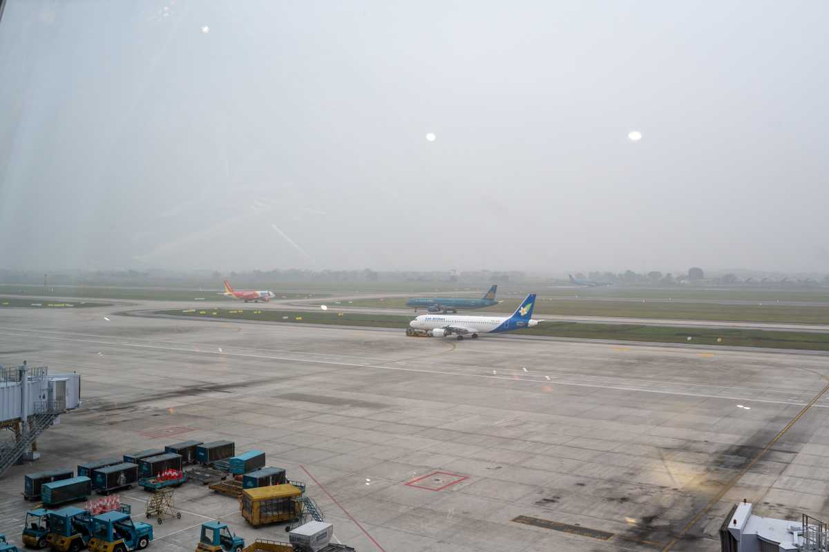 Buses and Shuttle Services at Noi Bai International Airport Fleet of shuttle buses and service vehicles parked at Noi Bai International Airport apron area