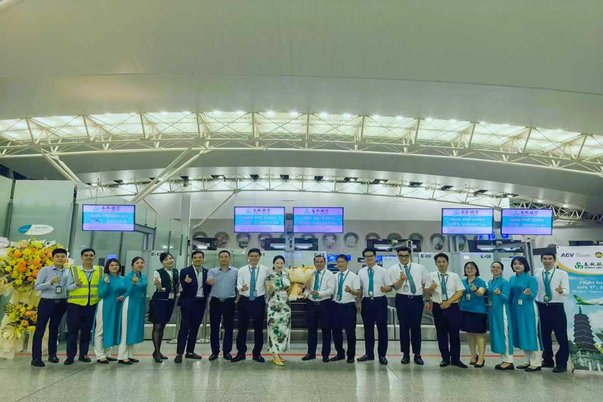 Noi Bai International Airport Staff Group Photo Smiling staff members posing inside Noi Bai International Airport terminal