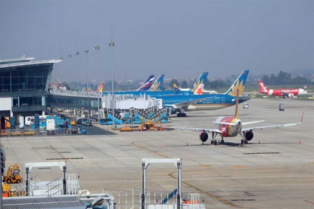 Passenger Waiting Area at Noi Bai International Airport Busy passenger waiting area inside Noi Bai International Airport with travelers seated and using devices