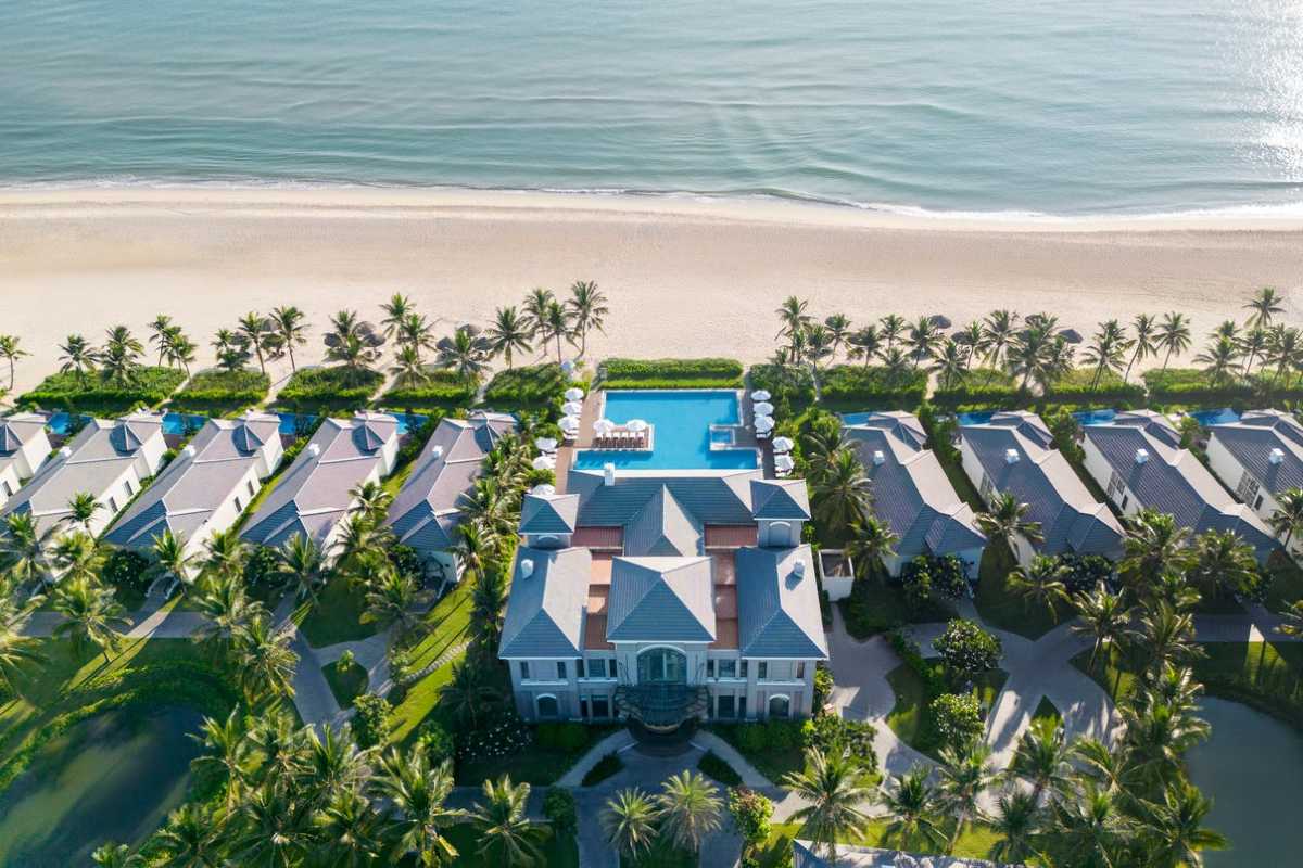 Non Nuoc Beach Da Nang aerial view of beachfront villas Non Nuoc Beach Da Nang showcases beachfront villas with private pools, lush palms, and immediate access to sandy shores and the sea.