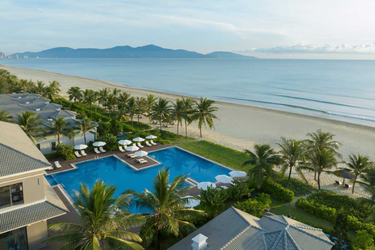 Non Nuoc Beach Da Nang sun loungers and ocean view tranquility Non Nuoc Beach Da Nang offers white sand, sun loungers beneath palm trees, and endless blue sea views, ideal for rest and scenic enjoyment.