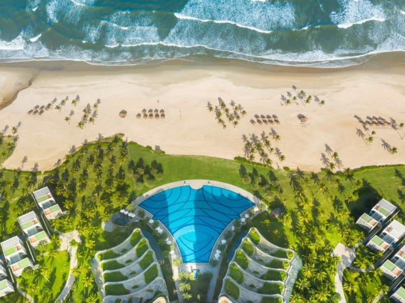 Aerial view of Non Nuoc Beach luxury resort, featuring beautiful villas and a stunning swimming pool.