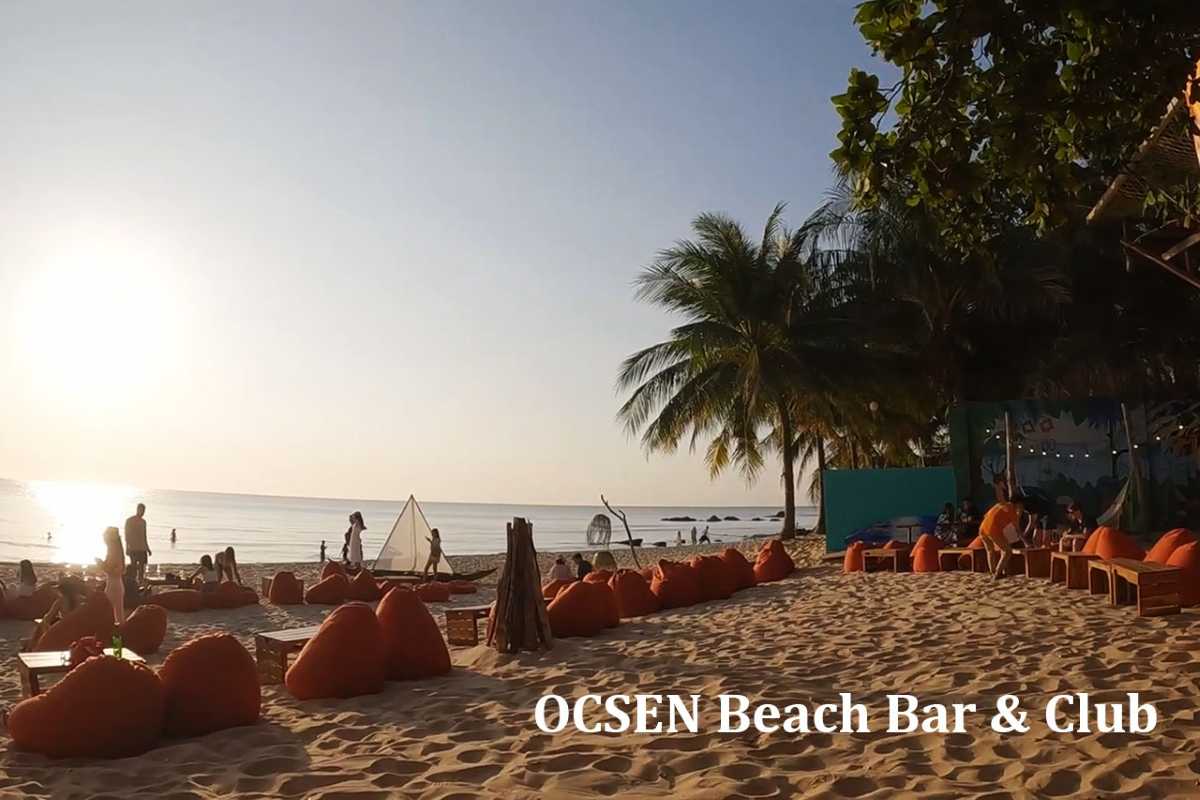 Beachfront lounge area at Oc Sen Beach Bar & Club on Phu Quoc Island with seating and palm trees