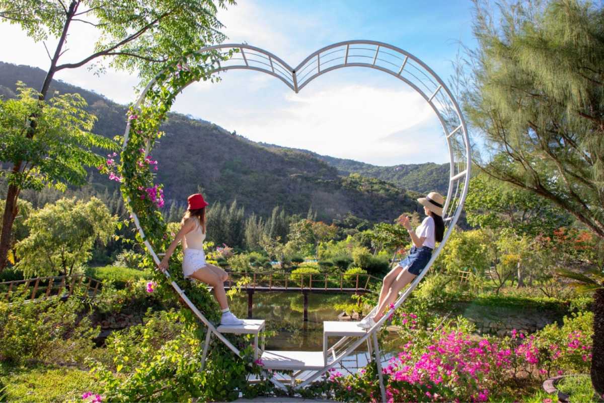 Orchid Stream Island Heart-Shaped Garden Frame Nha Trang Visitors posing in heart-shaped garden photo spot on Orchid Stream Island, Nha Trang