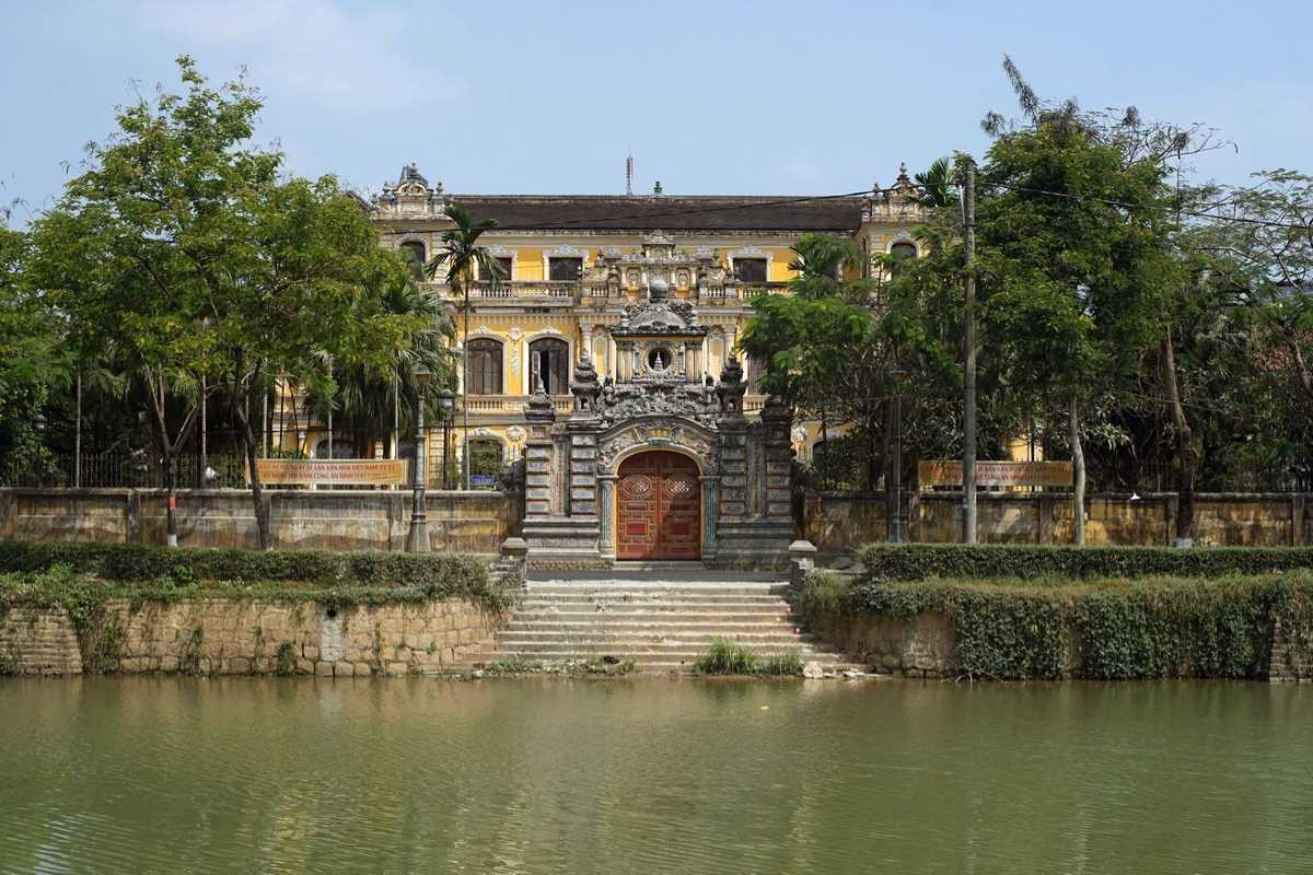 Ornate Side Entrance of An Dinh Palace Side entrance with detailed stone carvings and traditional roof at An Dinh Palace in Hue