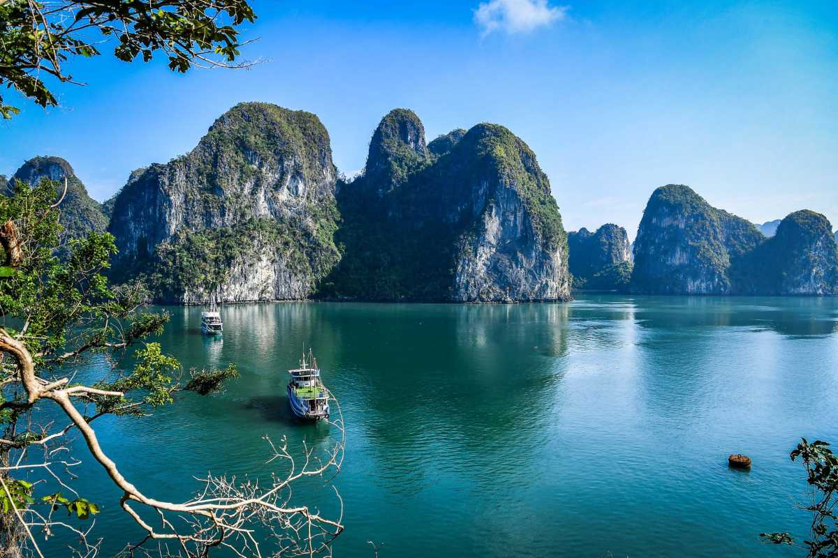Overlooking Halong Bay from Drum Cave interior View of boats and karst islands on Halong Bay seen from inside Drum Cave, offering visitors a peaceful retreat.
