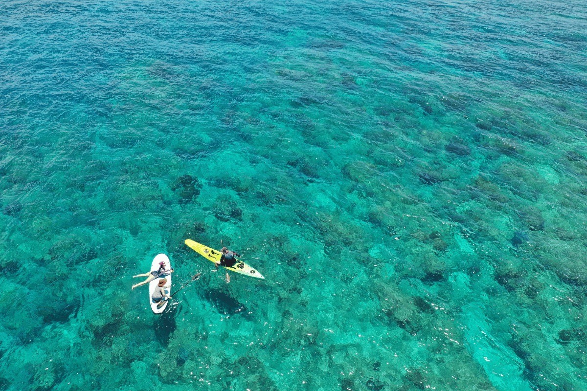 Paddleboarding and kayaking adventure at My Khe Beach with crystal clear waters.