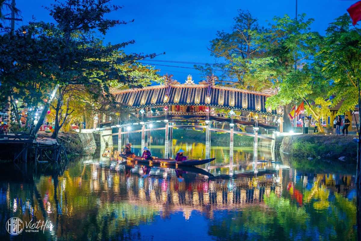 Panoramic View of Thanh Toan Bridge and Surroundings Wide-angle shot showing Thanh Toan Bridge crossing a peaceful river with greenery around