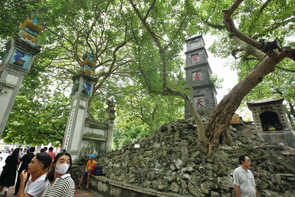 Pen Tower and Entrance Gates at Hoan Kiem Lake Pen Tower rising behind the traditional entrance gates surrounded by trees at Hoan Kiem Lake