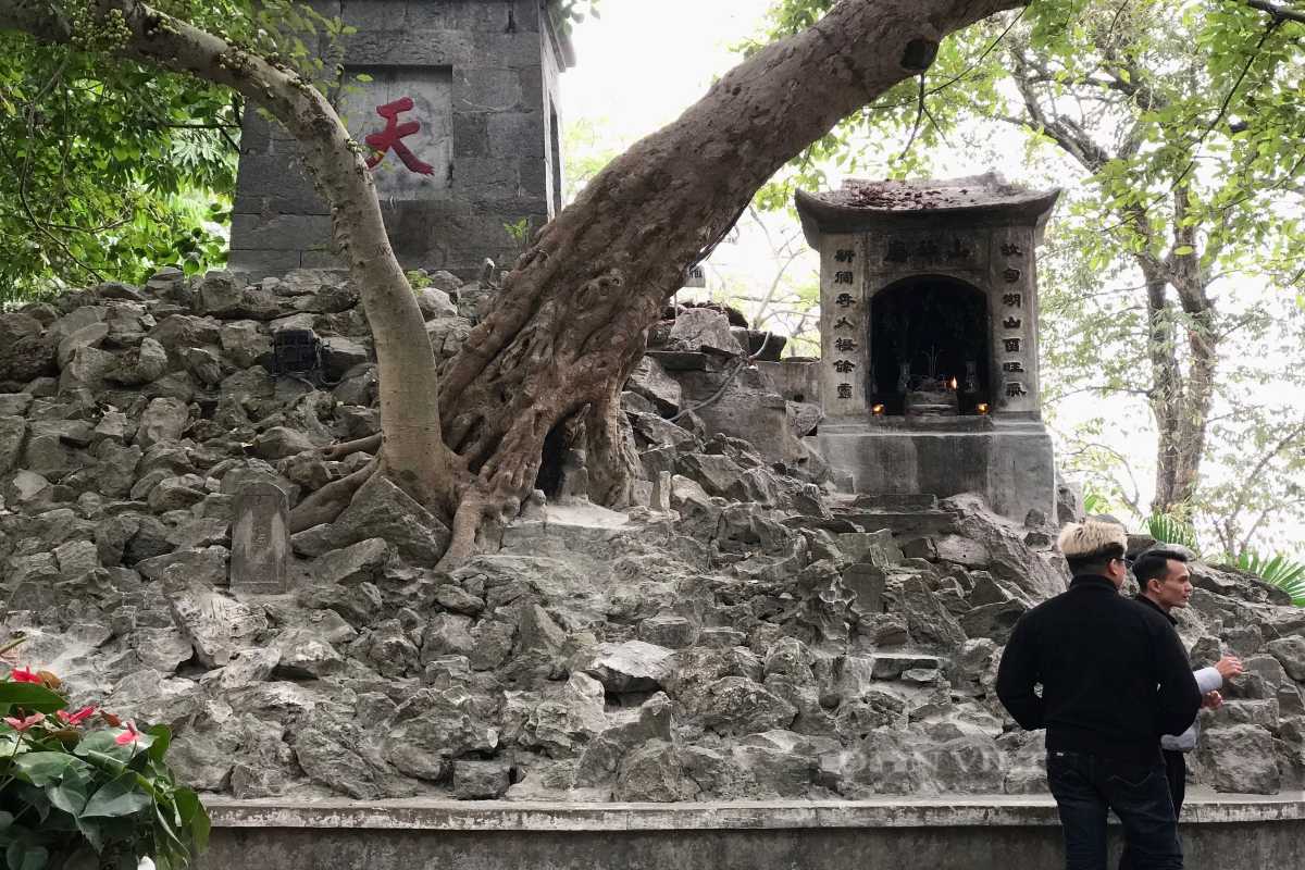 Pen Tower Shrine and Rocky Base at Hoan Kiem Lake Close-up of Pen Tower shrine atop rocky base with ancient trees at Hoan Kiem Lake