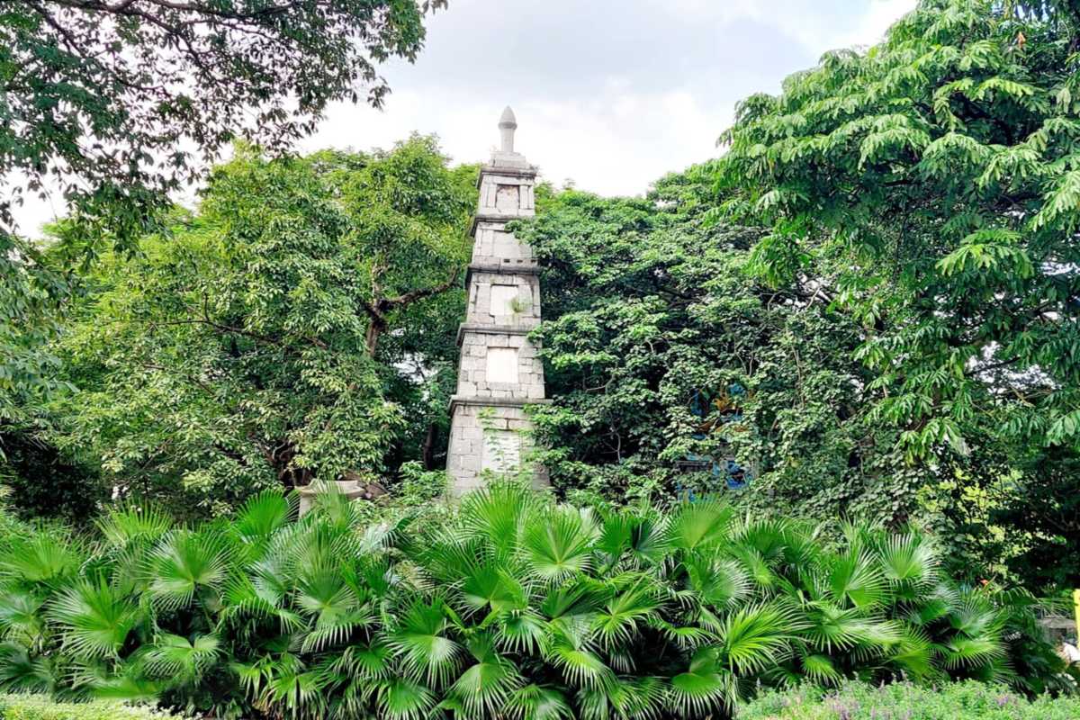 Pen Tower at Hoan Kiem Lake Framed by Tropical Plants View of Pen Tower framed by tropical plants and trees at Hoan Kiem Lake, Hanoi