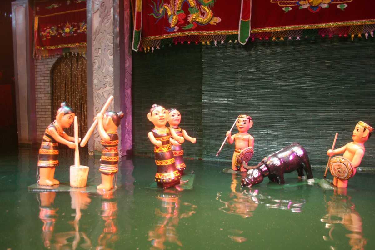 Performers and Musicians on Water Puppet Stage Performers and musicians in traditional attire on the water puppet stage during a live show
