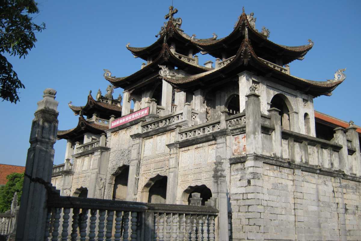 Phat Diem Cathedral Ninh Binh close-up main entrance Detailed close-up of the main stone entrance, ornate carvings, and layered roofs of Phat Diem Cathedral Ninh Binh.